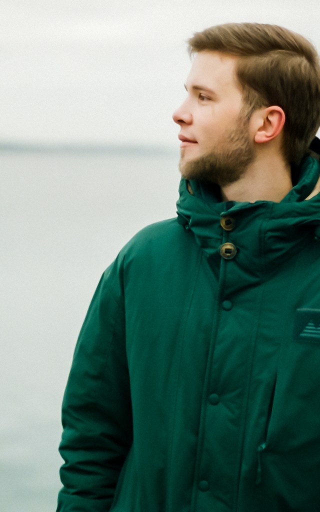 Artemy looking across a lake in the winter time